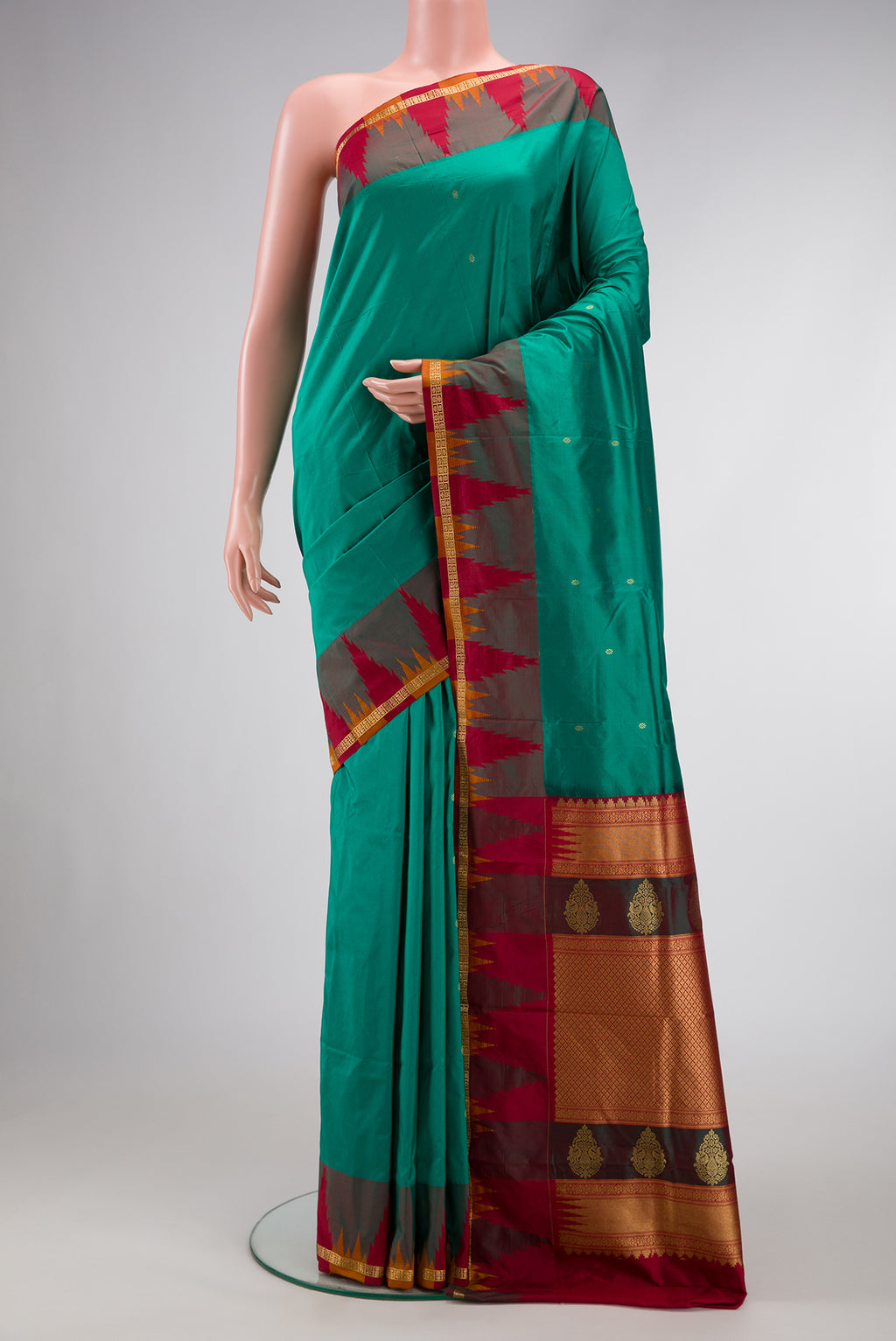 Green Dual Tone Kanchipuram Silk Saree with Zari Butta on the body and Zari Border.  displayed on a mannequin