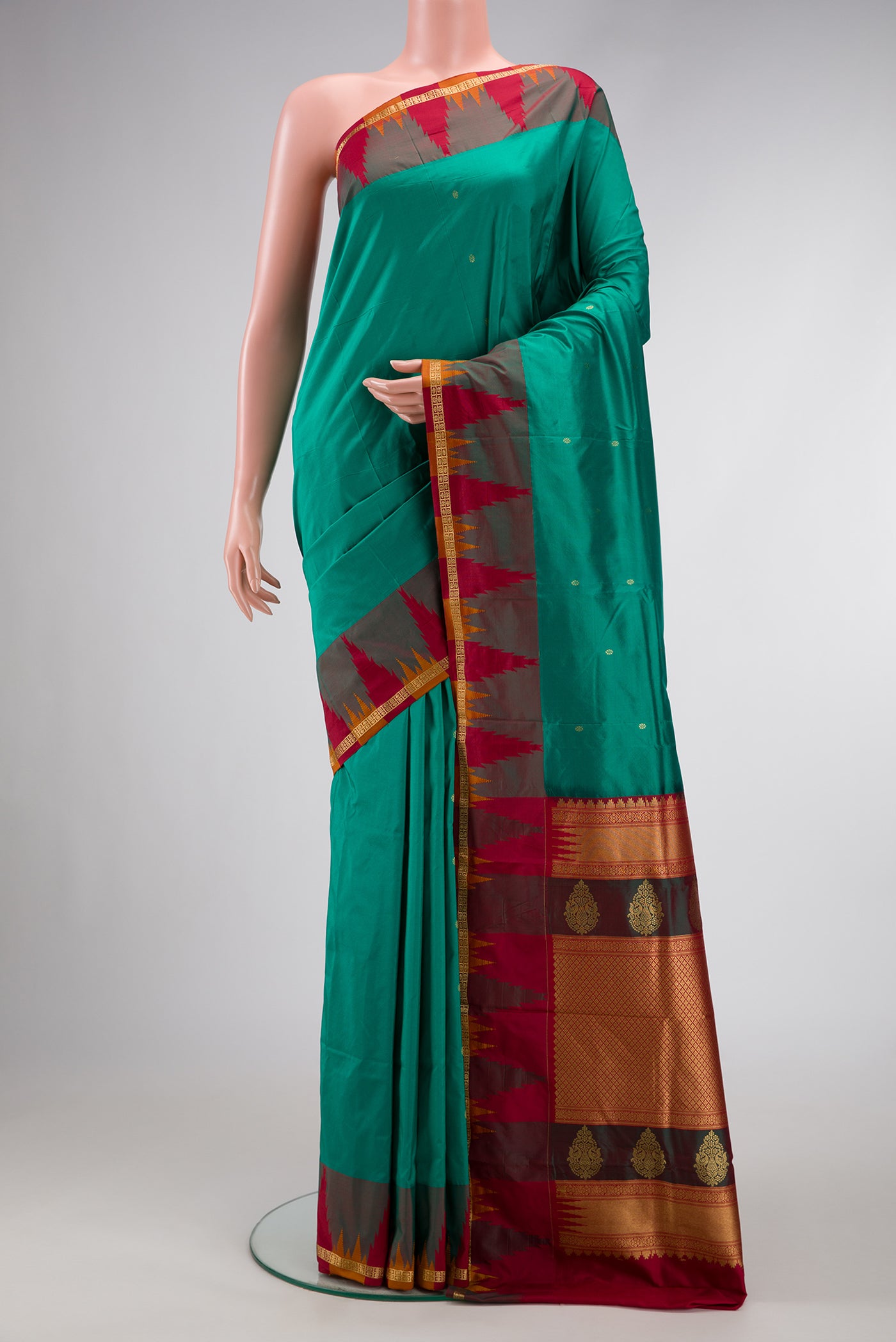 Green Dual Tone Kanchipuram Silk Saree with Zari Butta on the body and Zari Border.  displayed on a mannequin