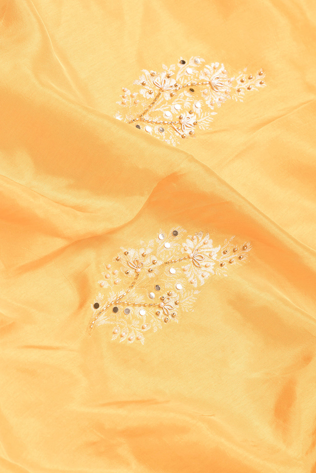 Close up of Yellow Dual Tone Mysore Georgette Saree with Embroidery on the body and Embroidery Border.  displaying folds