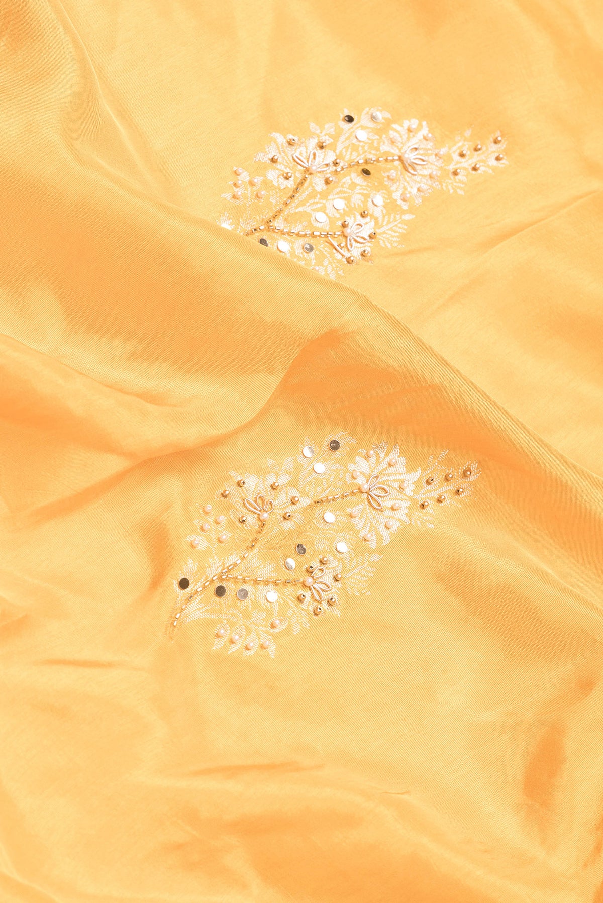 Close up of Yellow Dual Tone Mysore Georgette Saree with Embroidery on the body and Embroidery Border.  displaying folds