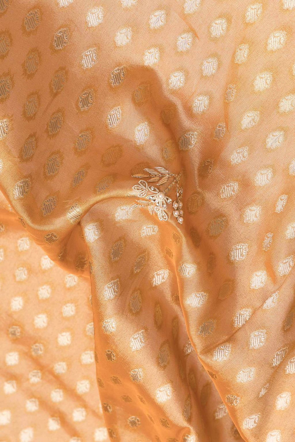 Close up of Brick Orange Dual Tone Mysore Georgette Saree with Embroidery on the body and Embroidery Border.  displaying folds