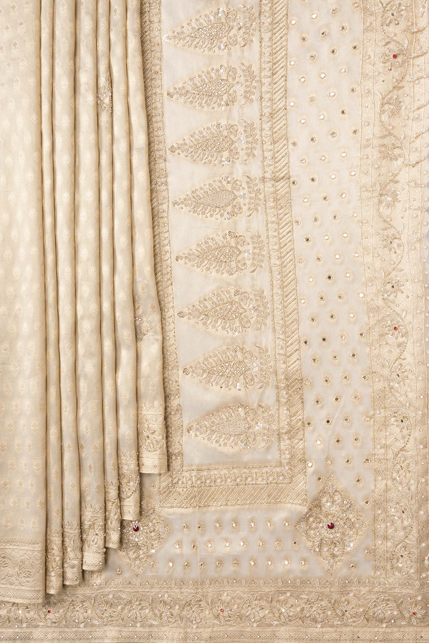 Pleats and pallu of Beige Dual Tone Organza Silk Saree with Zari Brocade on the body and Embroidery Border. 