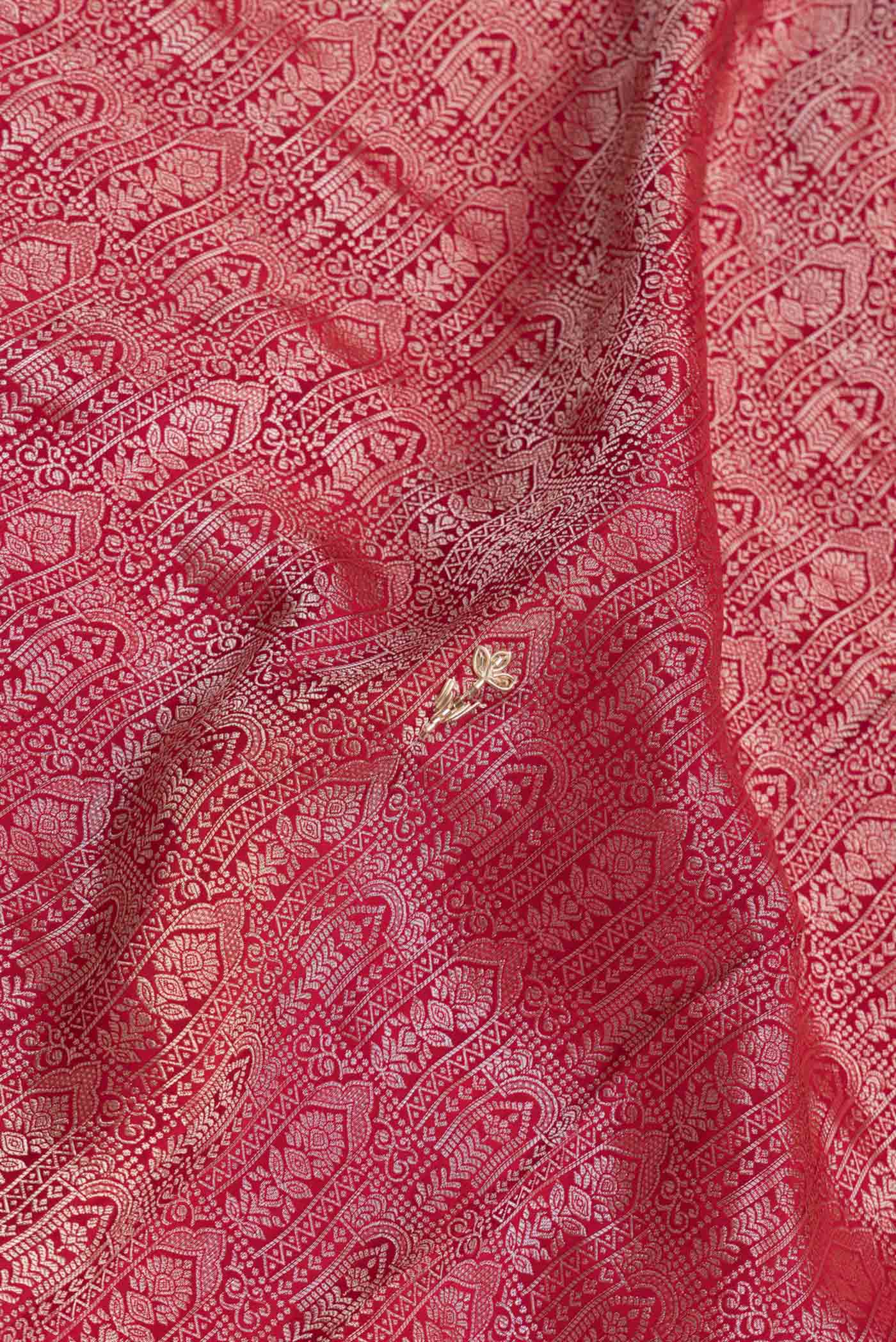 Close up of Red Dual Tone Mysore Crepe Saree with Zari Brocade on the body and Embroidery Border.  displaying folds