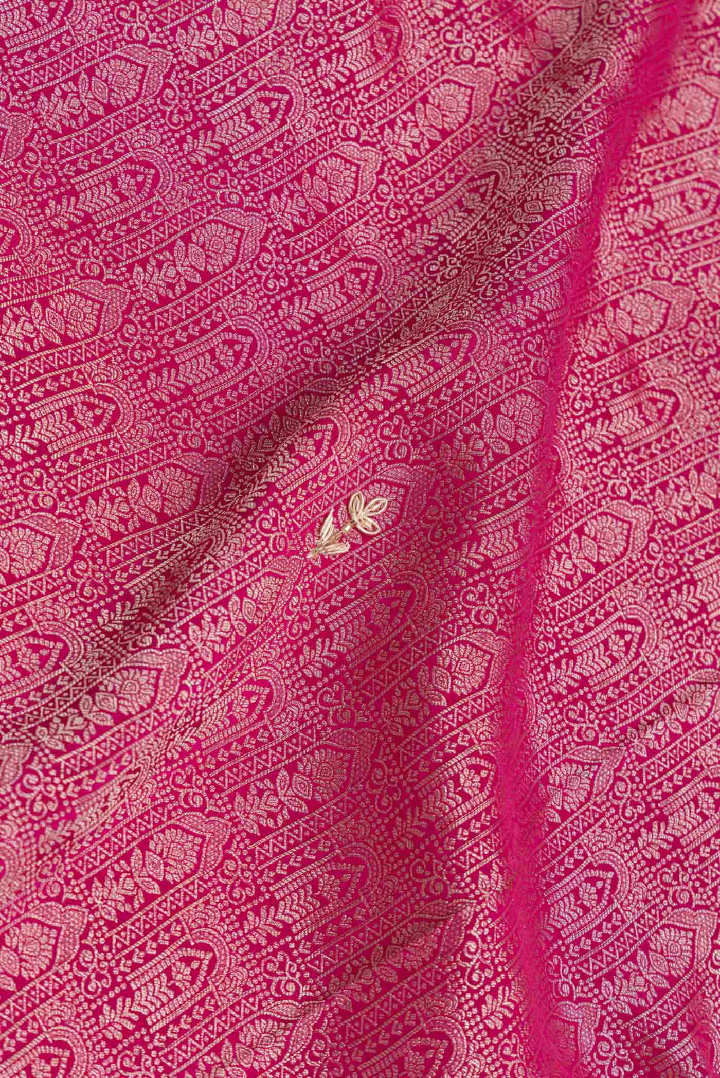 Close up of Pink Dual Tone Mysore Crepe Saree with Zari Brocade on the body and Embroidery Border.  displaying folds