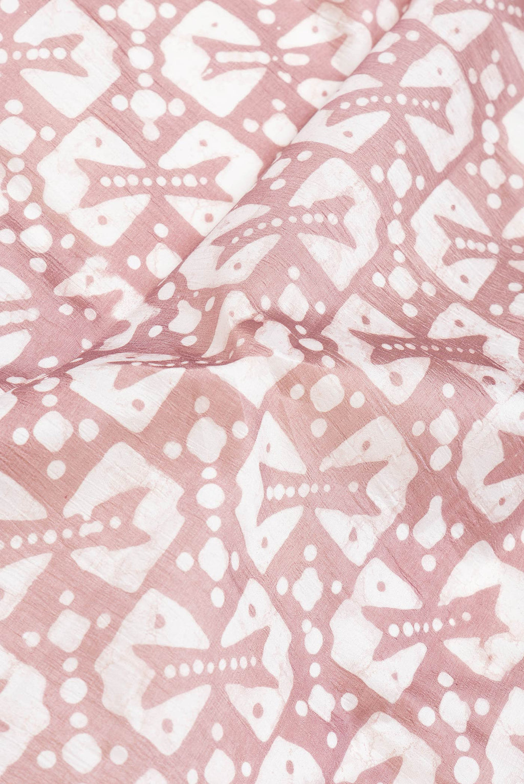 Close up of Brown Dual Tone Tussar Silk Saree with Printed design on the body and Printed Border.  displaying folds