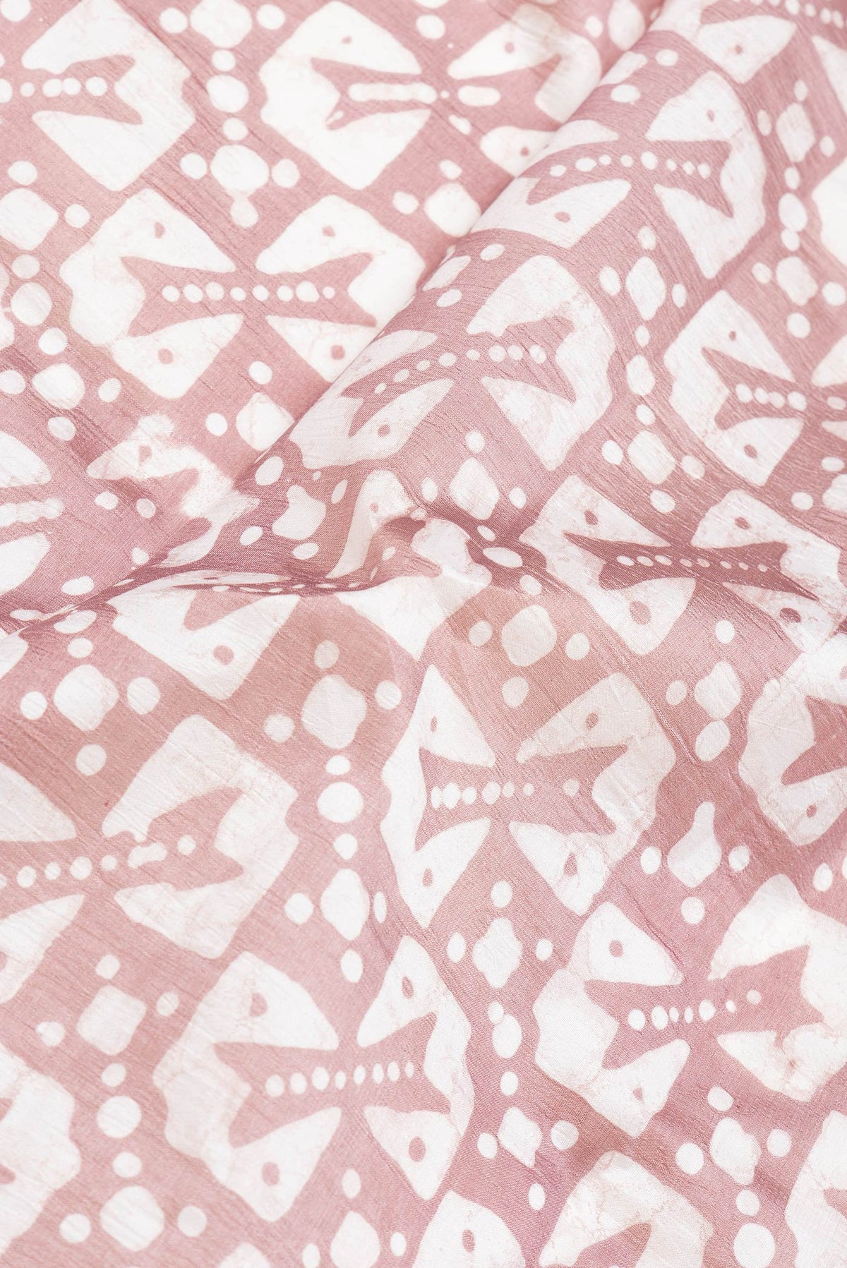 Close up of Brown Dual Tone Tussar Silk Saree with Printed design on the body and Printed Border.  displaying folds