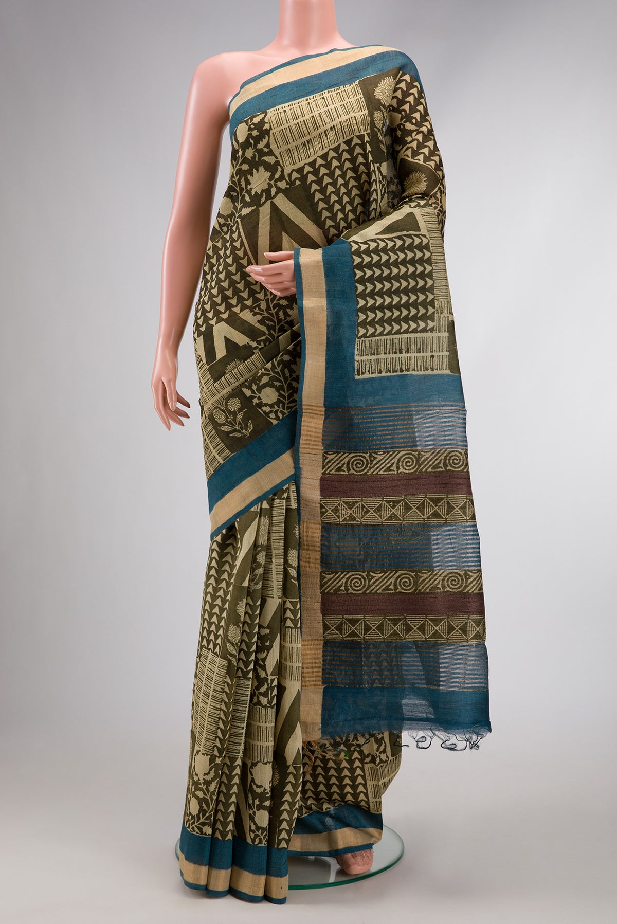 Mehandi Green Dual Tone Tussar Silk Saree with Printed design on the body and Zari Border.  displayed on a mannequin