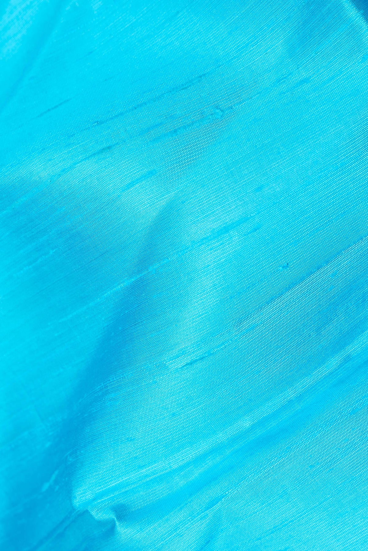Close up of Sky Blue Dual Tone Raw Saree with Plain Body and Zari Border.  displaying folds
