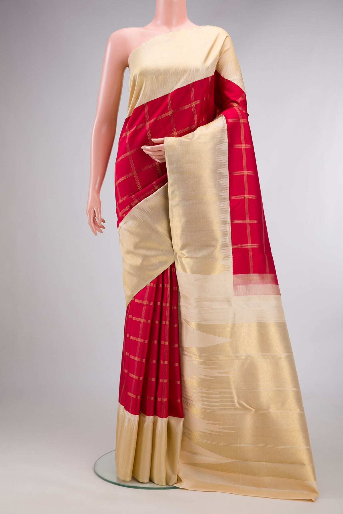 Pure Silk Pure Zari Red Kanjivaram Saree with Checked design on the body and Temple Border.  displayed on a mannequin