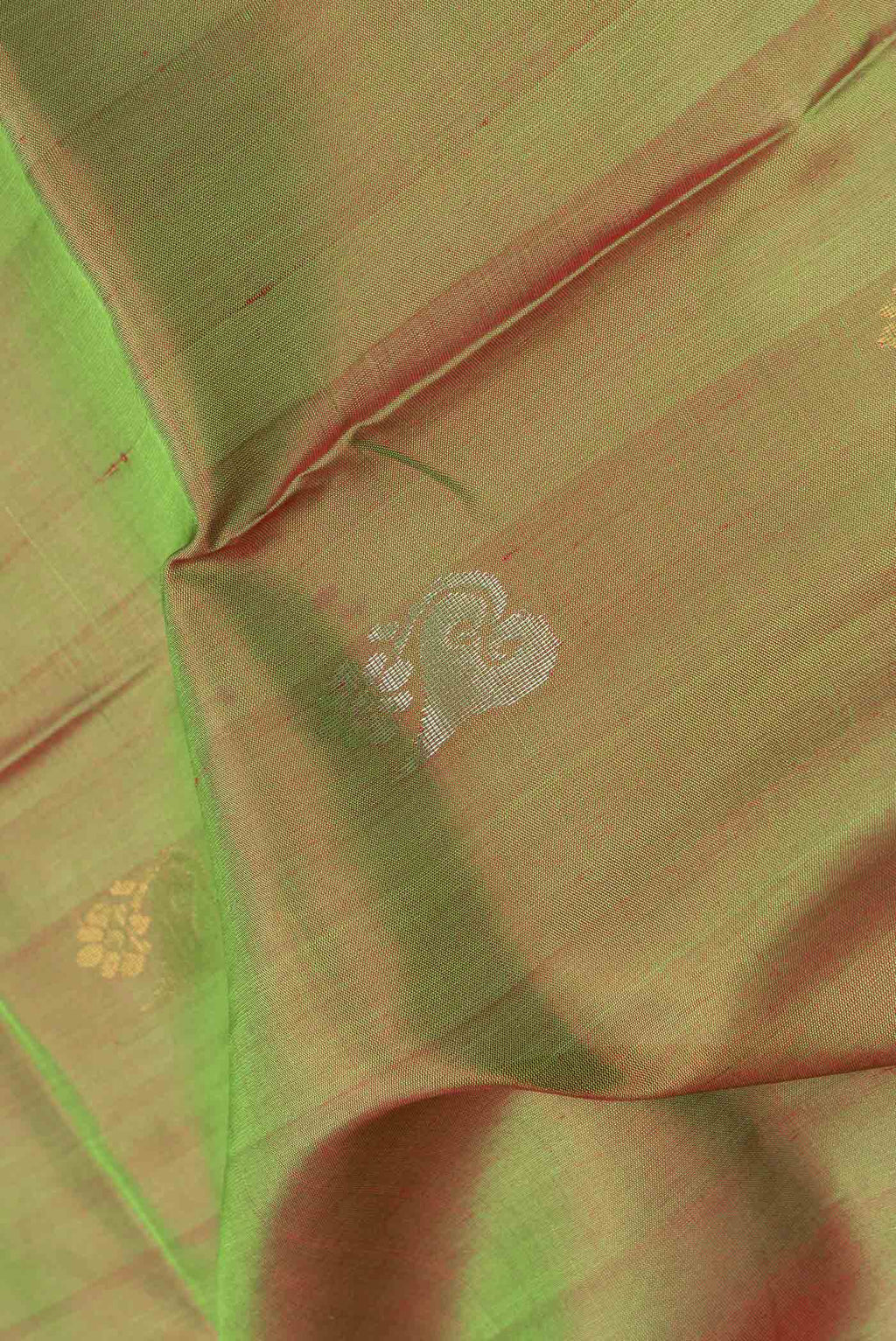 Close up of Mehandi Green Dual Tone Uppada Silk Saree with Zari Butta on the body and Zari Border.  displaying folds