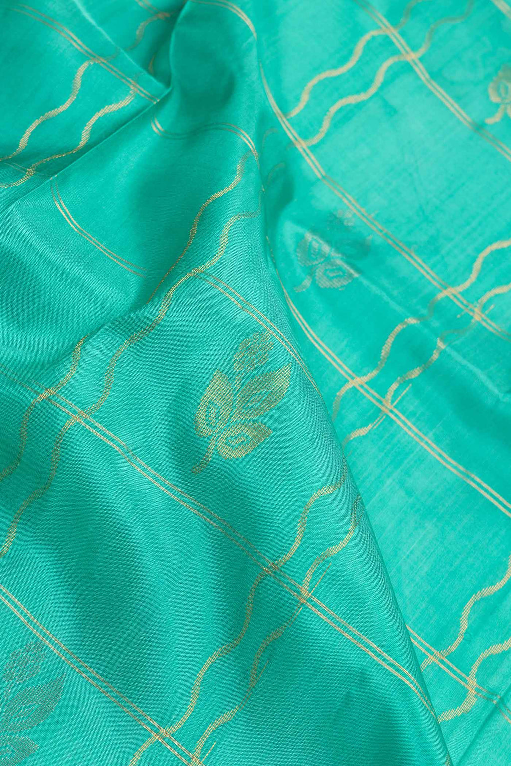 Close up of Sea Green Dual Tone Uppada Silk Saree with Checked design on the body and Zari Border.  displaying folds