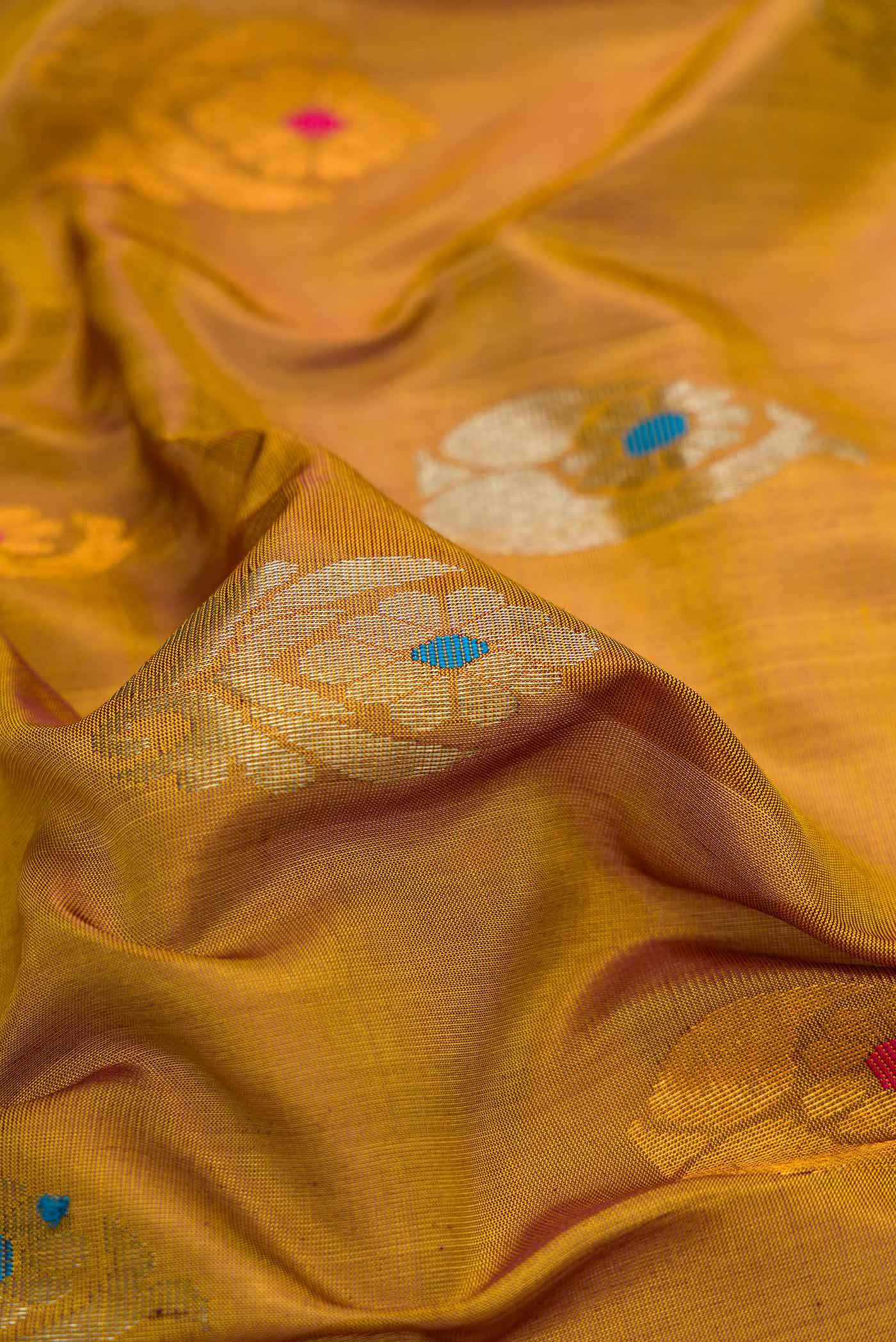 Close up of Mehandi Green Dual Tone Uppada Silk Saree with Zari And Thread Butta on the body and Zari Border.  displaying folds