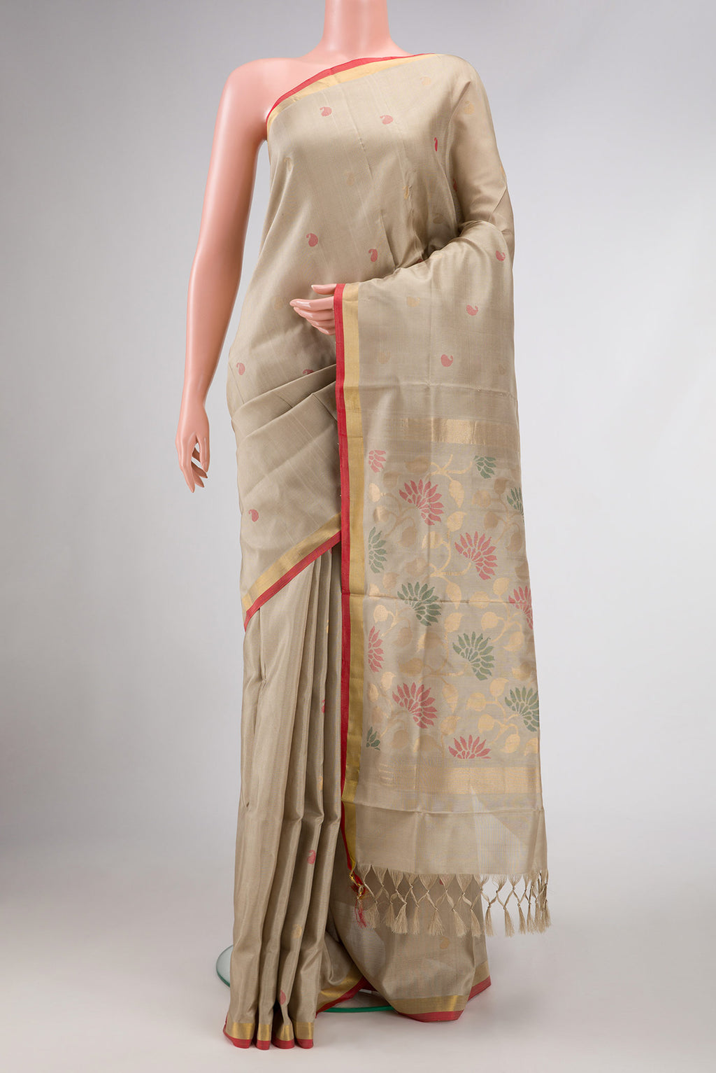 Beige Dual Tone Uppada Silk Saree with Zari And Thread Butta on the body and Zari Border.  displayed on a mannequin
