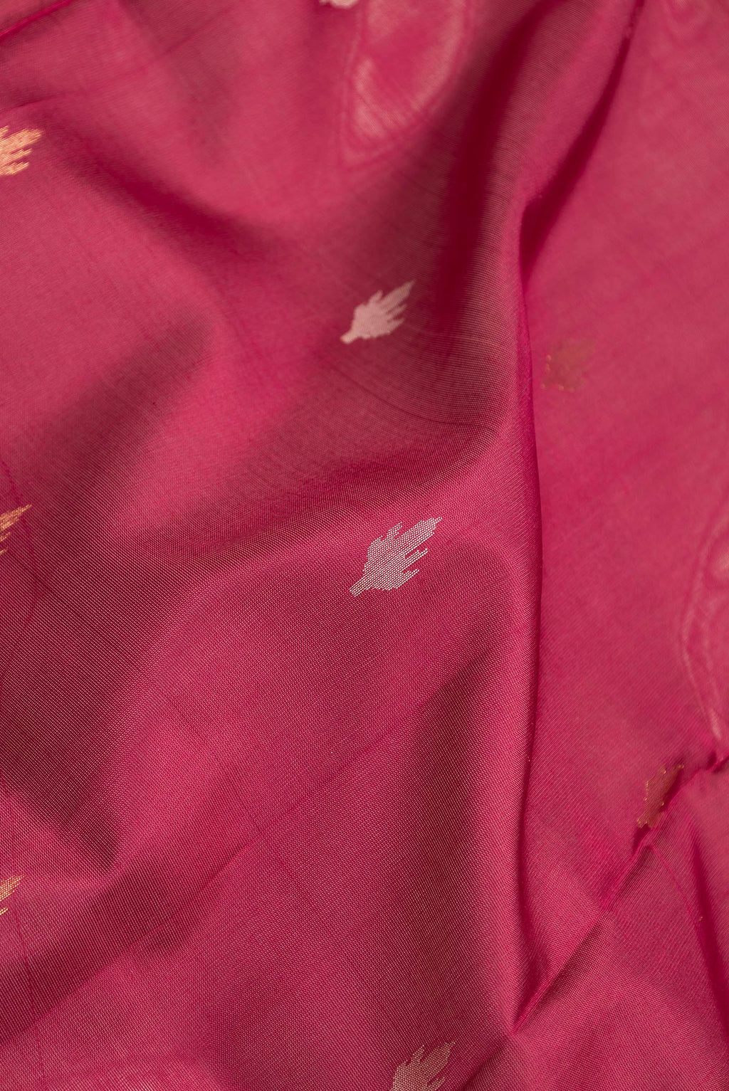 Close up of Maroon Dual Tone Uppada Silk Saree with Zari Butta on the body and Zari Border.  displaying folds