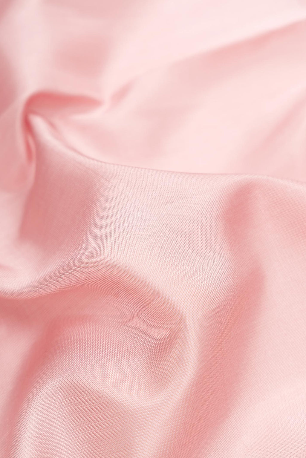 Close up of Pink Dual Tone Uppada Silk Saree with Zari Butta on the body and Fancy Border.  displaying folds