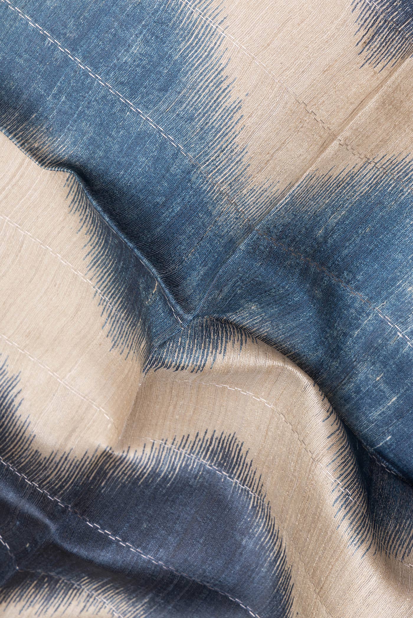 Close up of Beige Tussar Silk Saree with Stripes on the body and Zari Border.  displaying folds