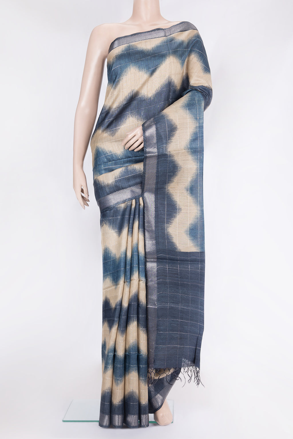 Beige Tussar Silk Saree with Stripes on the body and Zari Border.  displayed on a mannequin