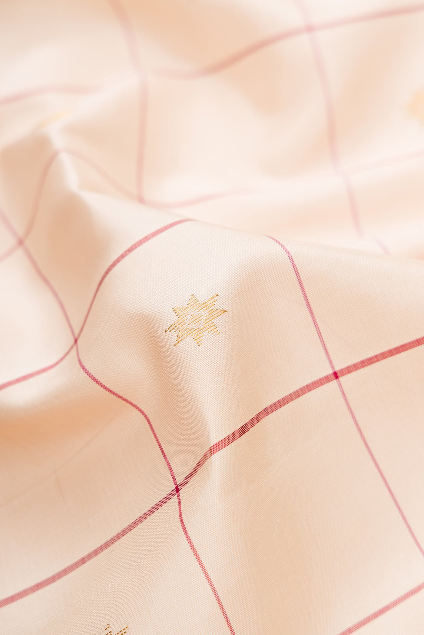 Close up of Sandal Dual Tone Kanjivaram Silk Saree with Checked design on the body and Zari Border.  displaying folds