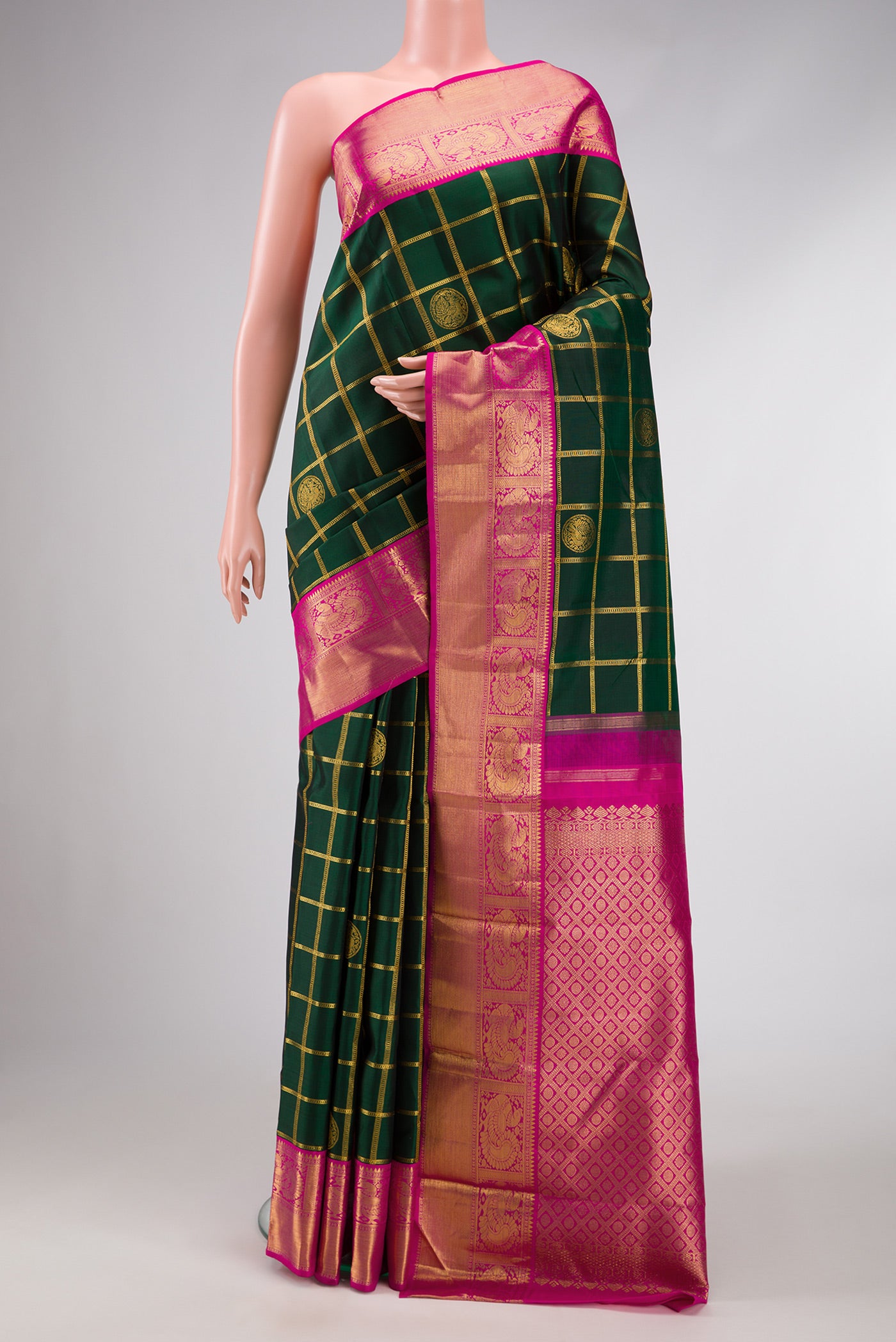 Pure Silk Pure Zari Bottle Green Dual Tone Kanjivaram Saree with Checked design on the body and Zari Border.  displayed on a mannequin