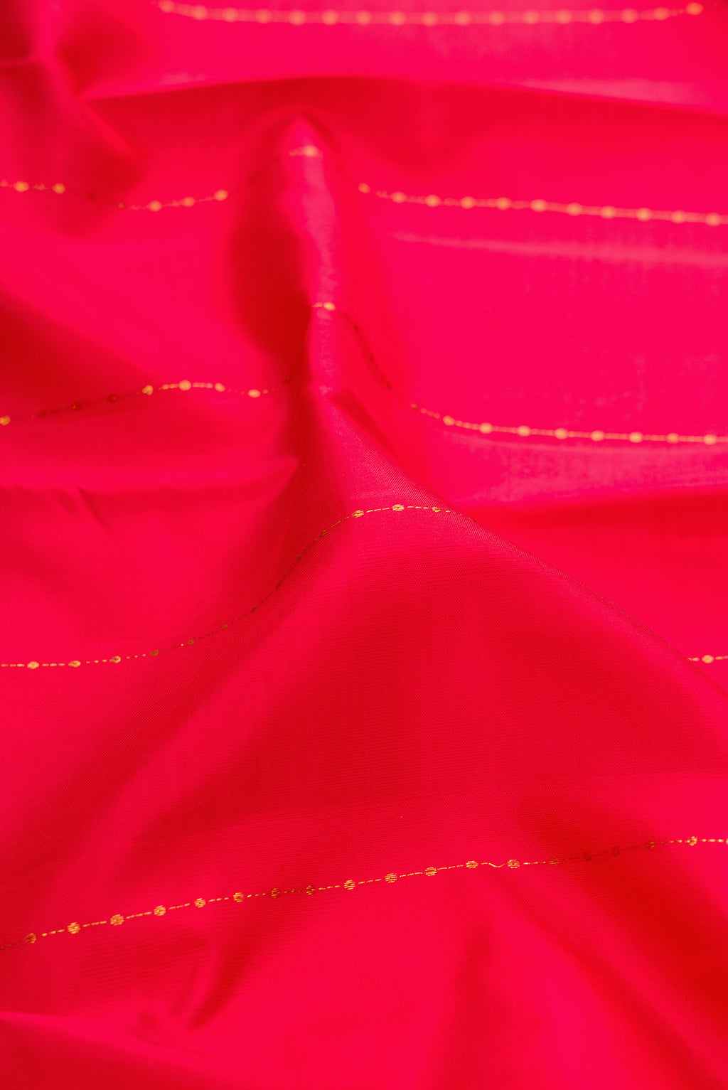 Close up of Red Kanjivaram Silk Saree with Stripes on the body and Zari Border.  displaying folds