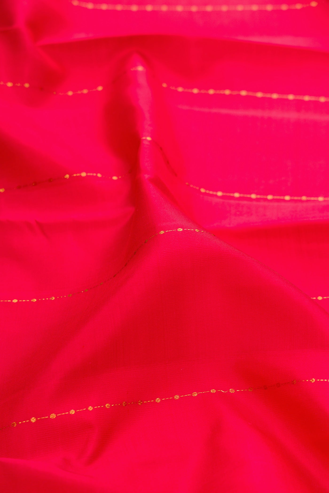 Close up of Red Kanjivaram Silk Saree with Stripes on the body and Zari Border.  displaying folds