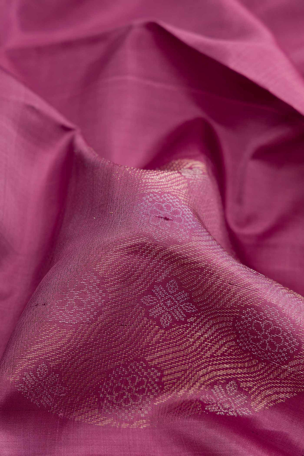 Close up of Purple Dual Tone Soft Silk Saree with Zari Butta on the body and Without Border.  displaying folds