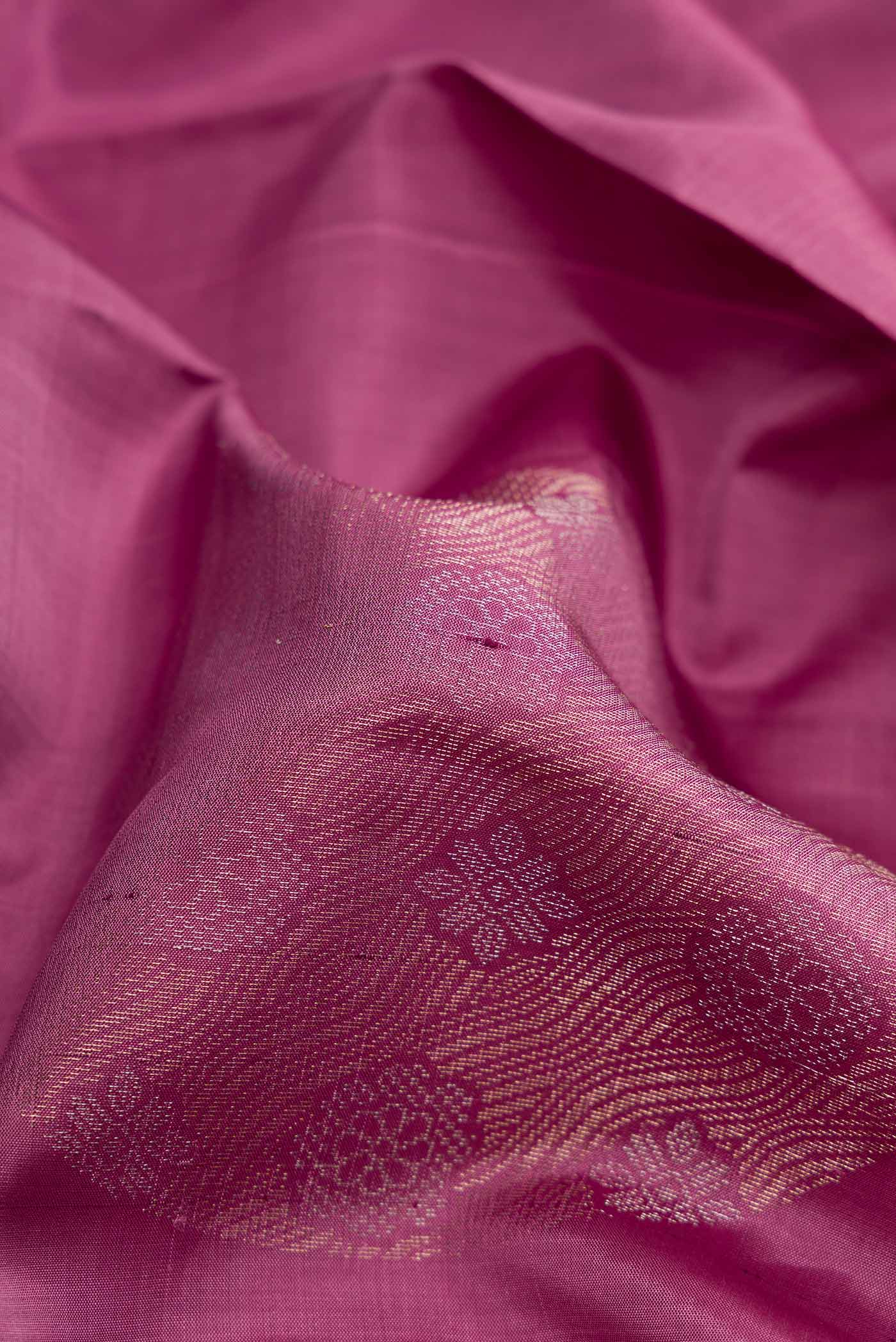 Close up of Purple Dual Tone Soft Silk Saree with Zari Butta on the body and Without Border.  displaying folds
