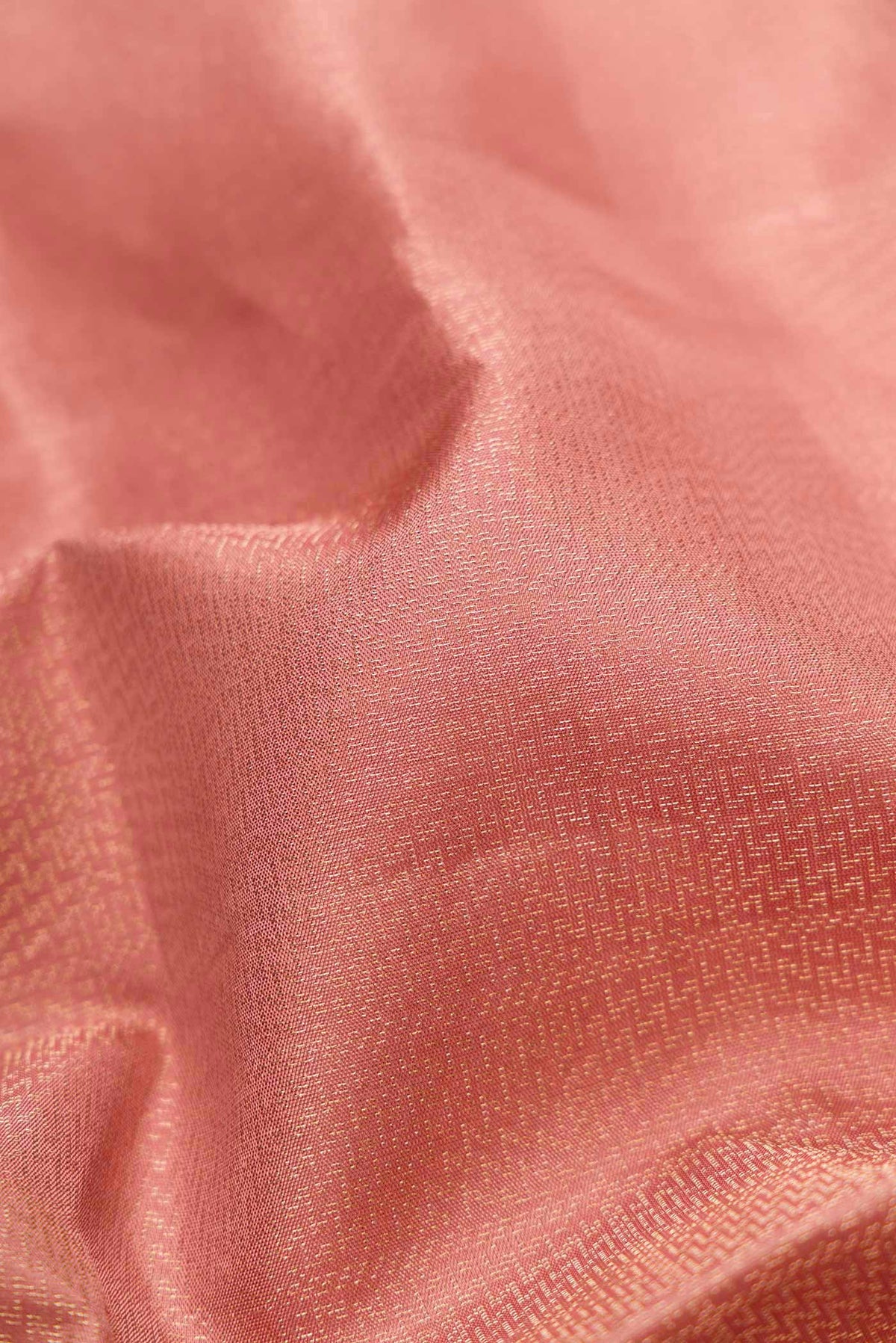Close up of Golden Peach Dual Tone Soft Silk Saree with Zari Brocade on the body and Zari Border.  displaying folds