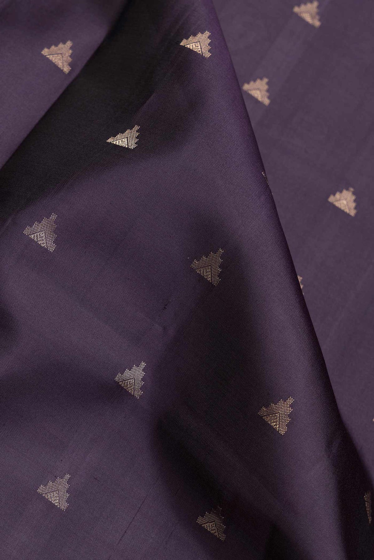 Close up of Navy Blue Dual Tone Soft Silk Saree with Zari Butta on the body and Zari Border.  displaying folds