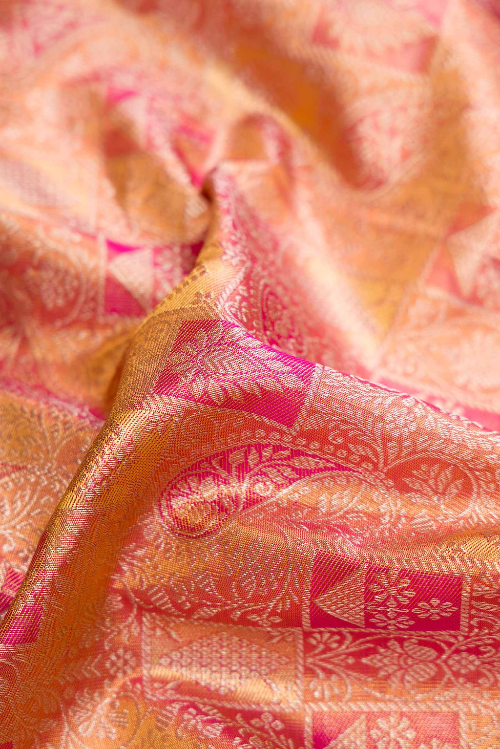 Close up of Pink Dual Tone Kanjivaram Tissue Silk Saree with Zari Brocade on the body and Zari Border.  displaying folds