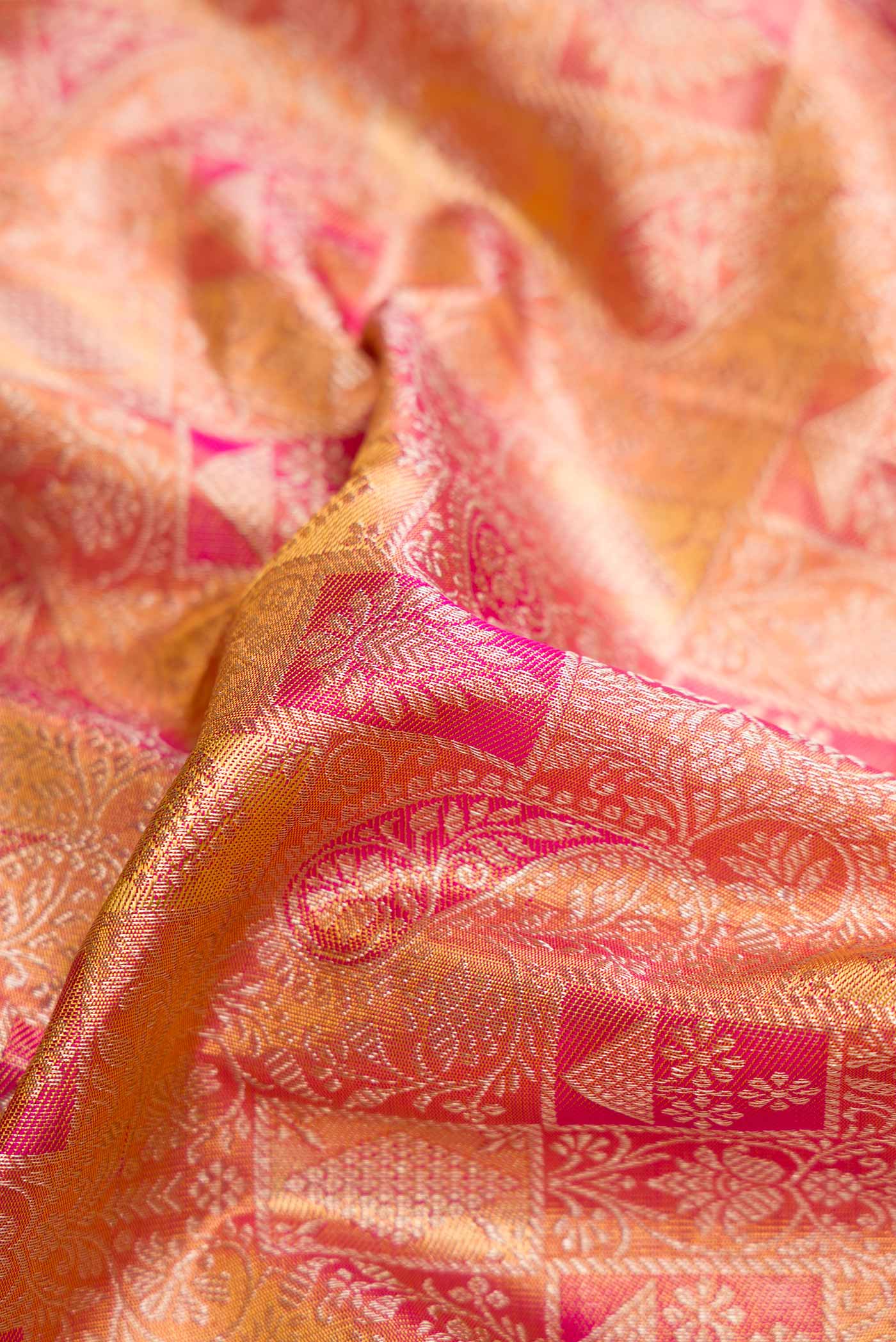 Close up of Pink Dual Tone Kanjivaram Tissue Silk Saree with Zari Brocade on the body and Zari Border.  displaying folds