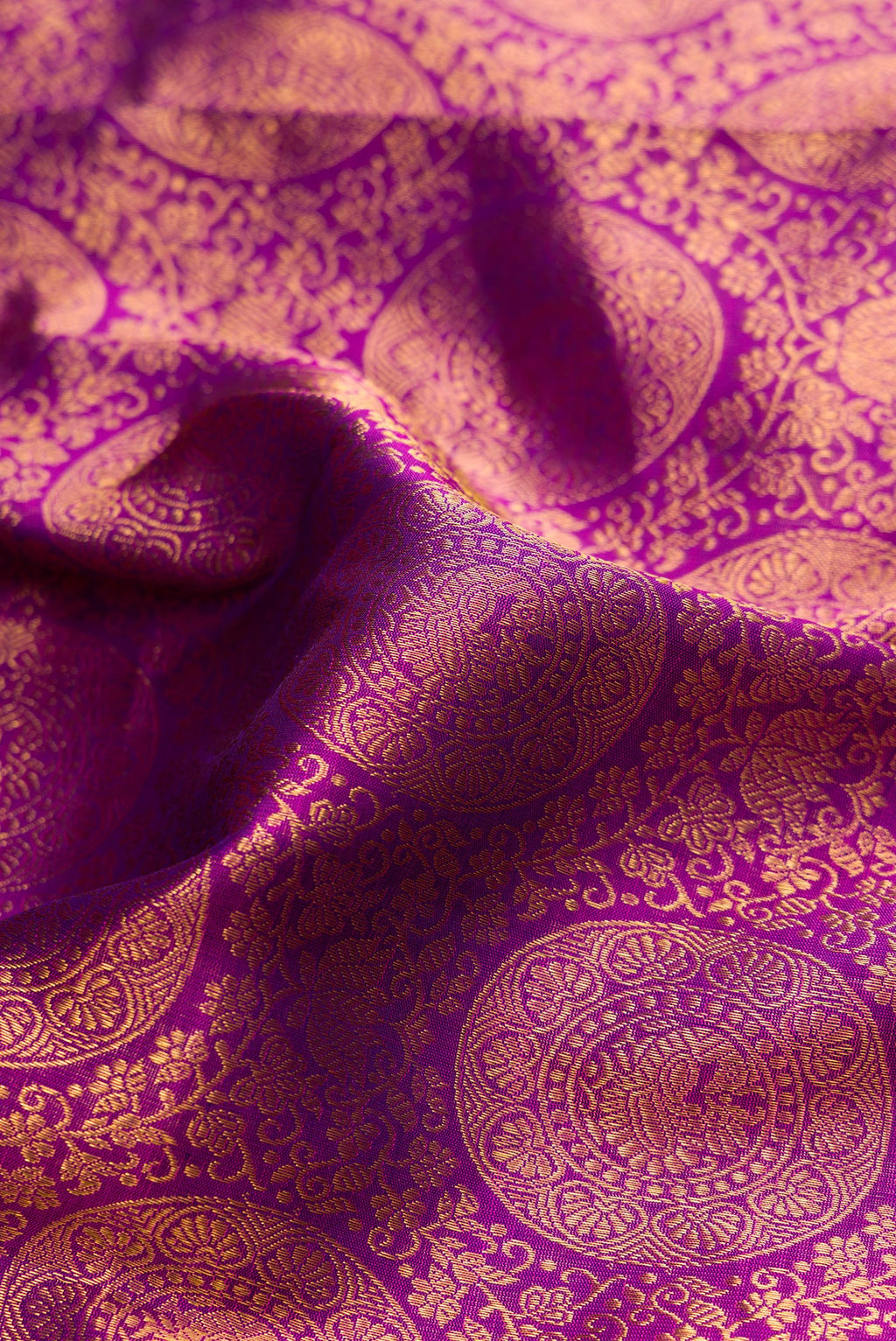 Close up of Purple Dual Tone Kanchipuram Silk Saree with Zari Brocade on the body and Zari Border.  displaying folds