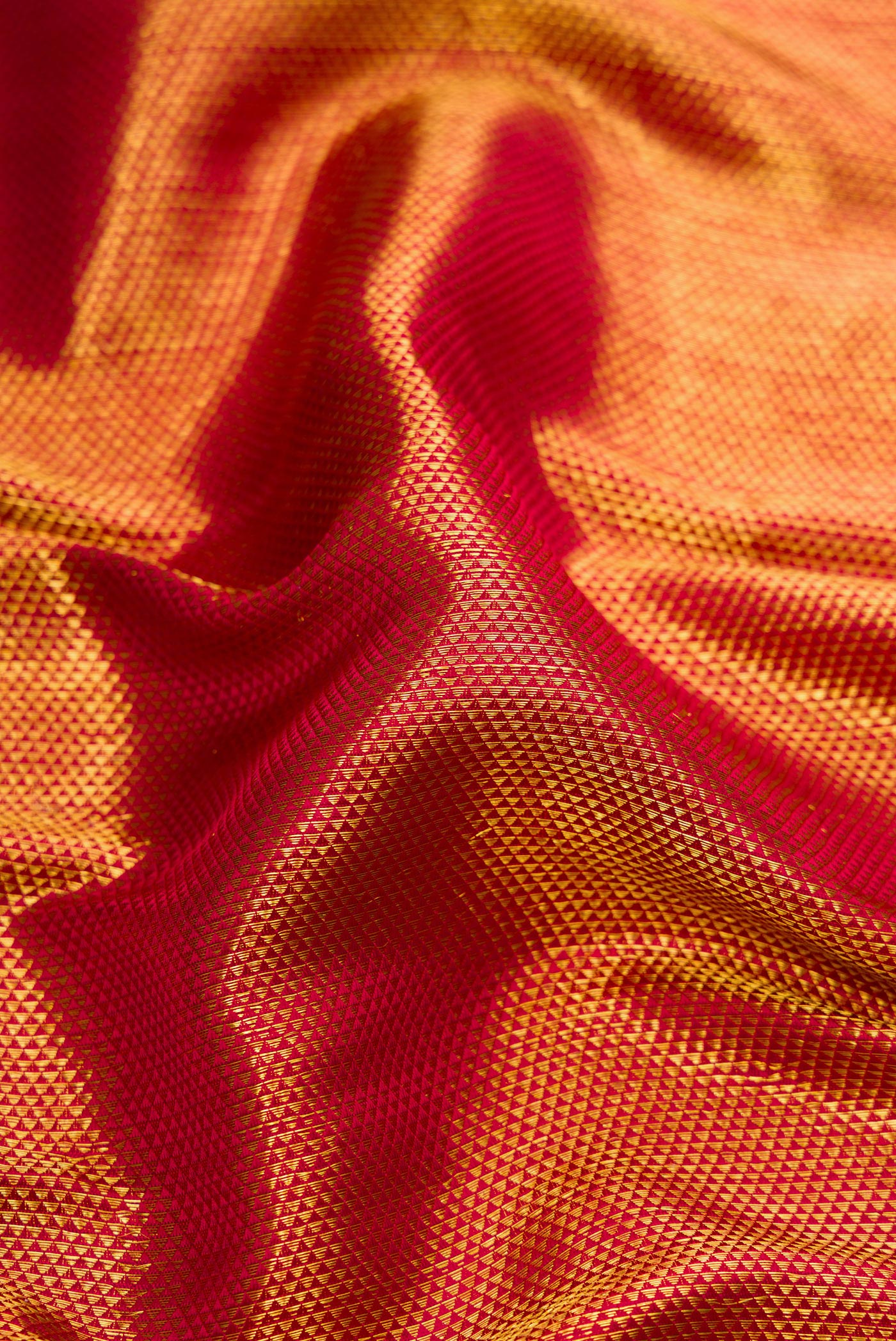 Close up of Maroon Dual Tone Kanchipuram Silk Saree with Zari Brocade on the body and Zari Border.  displaying folds