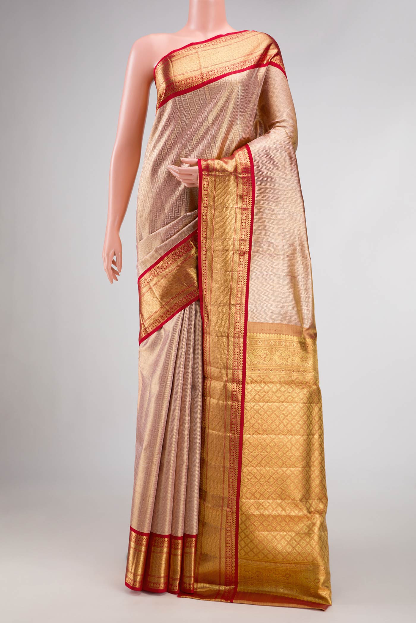Rose Gold Dual Tone Kanjivaram Tissue Silk Saree with Zari Brocade on the body and Zari Border.  displayed on a mannequin