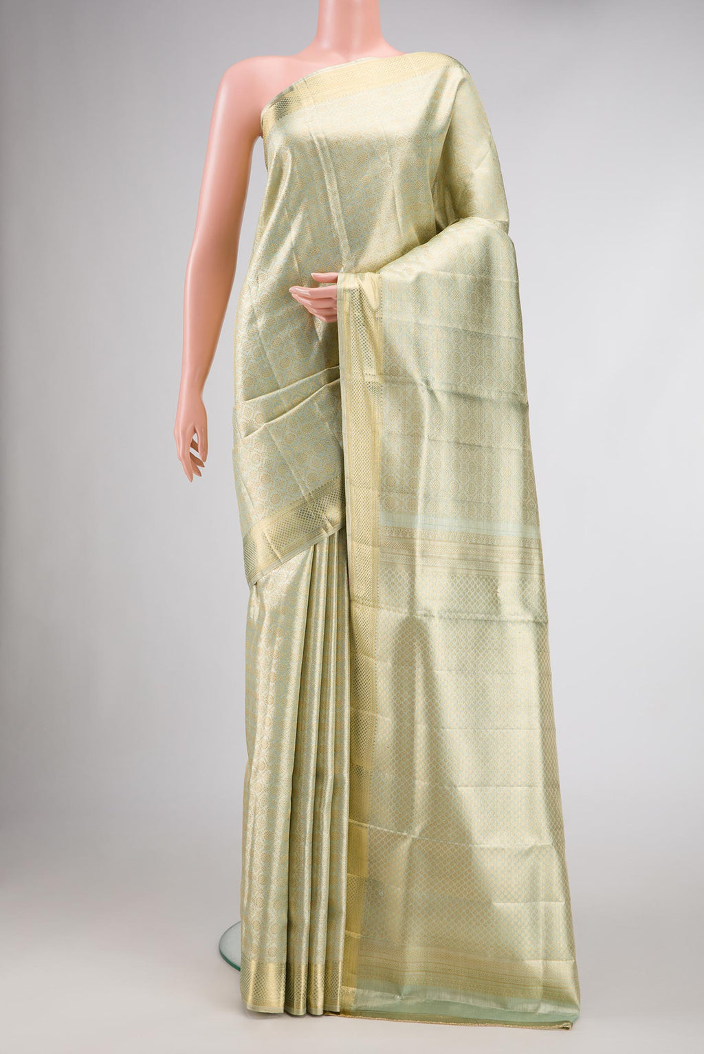 Light Green Dual Tone Kanjivaram Tissue Silk Saree with Zari Brocade on the body and Zari Border.  displayed on a mannequin
