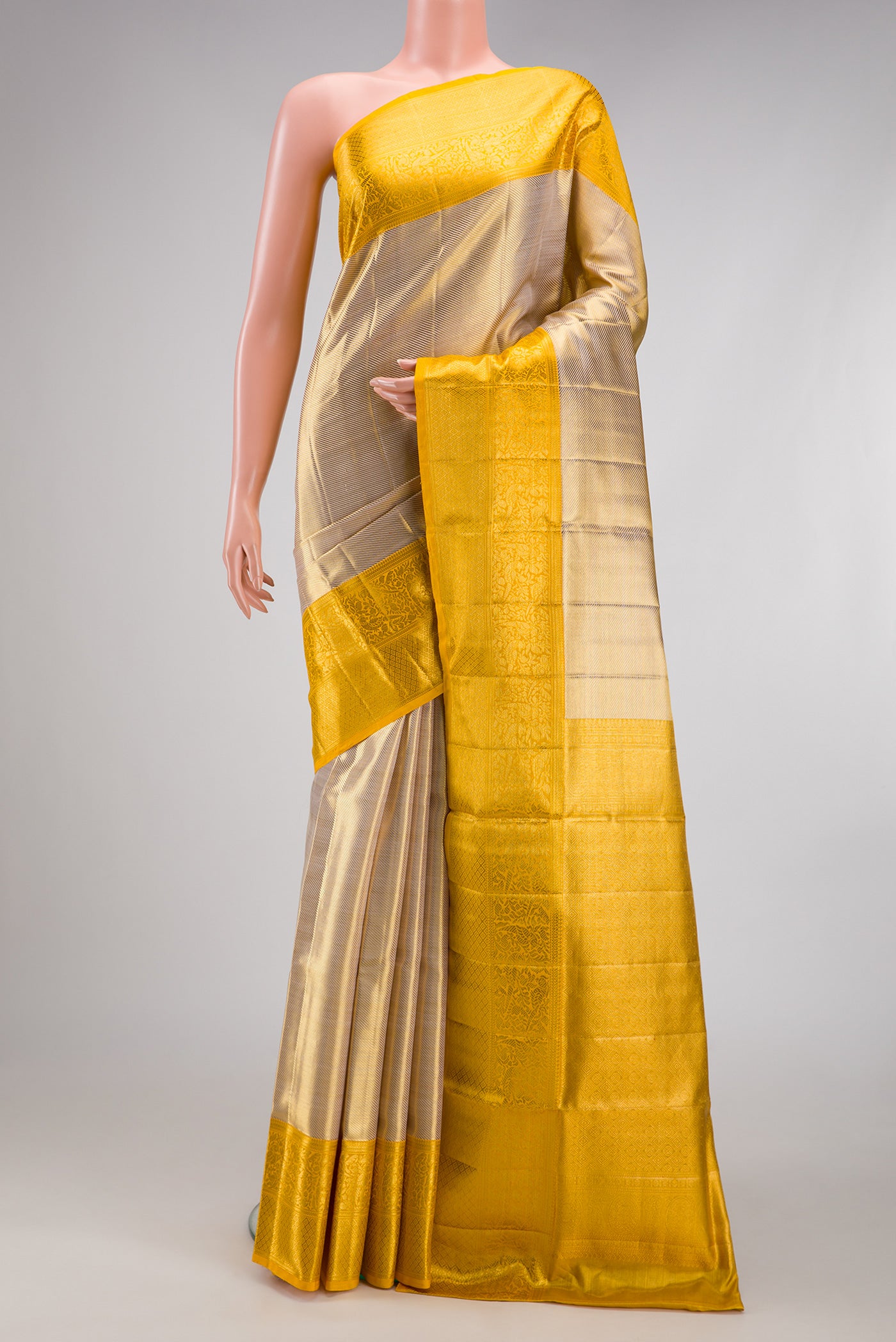 Rose Gold Dual Tone Kanjivaram Tissue Silk Saree with Zari Brocade on the body and Zari Border.  displayed on a mannequin
