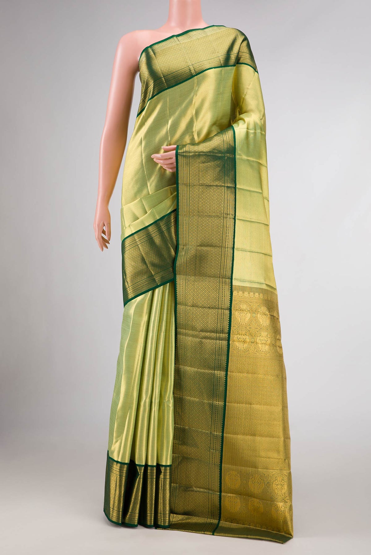 Pista Green Dual Tone Kanjivaram Silk Saree with Zari Brocade on the body and Zari Border.  displayed on a mannequin