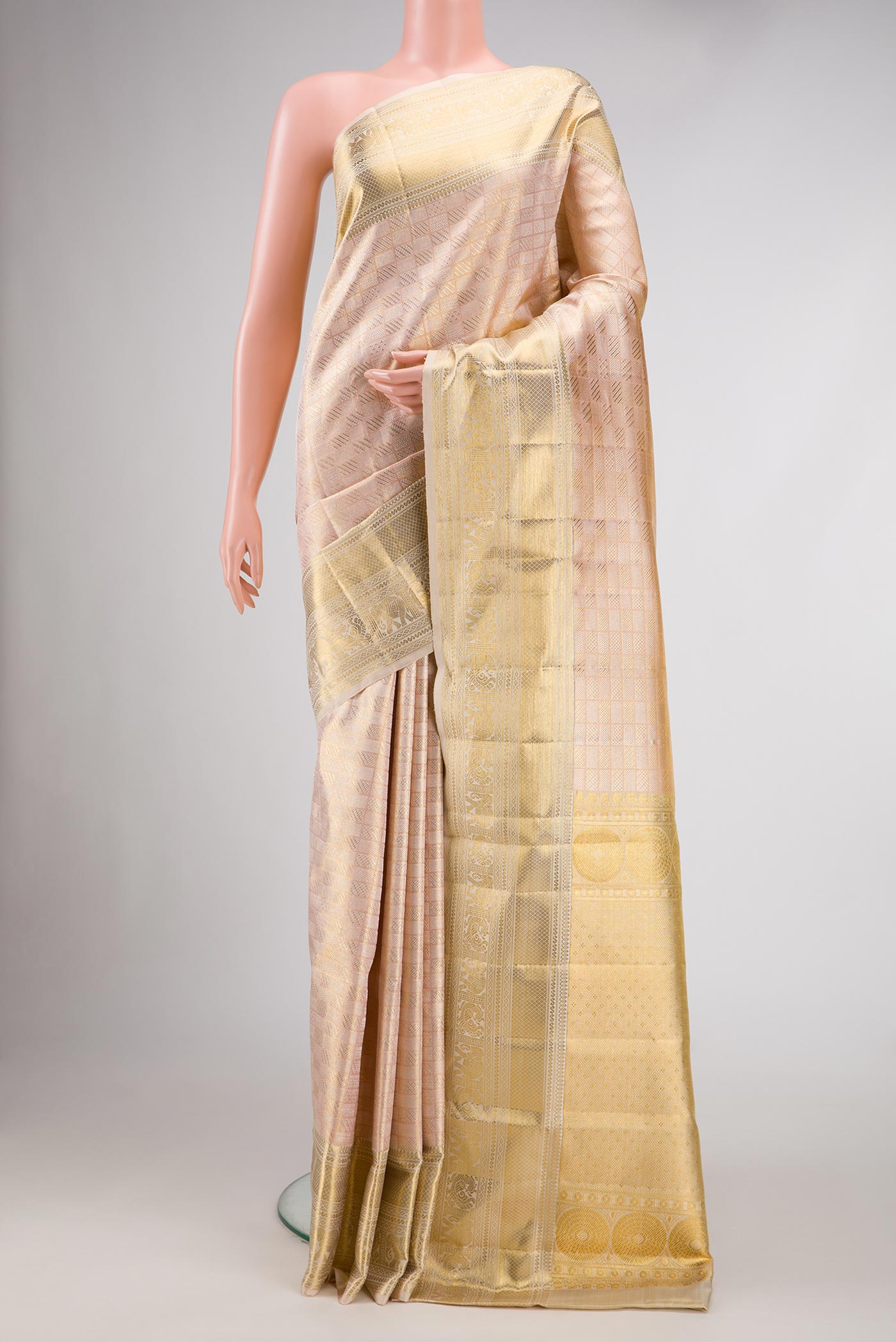 Rose Gold Dual Tone Kanjivaram Silk Saree with Zari Brocade on the body and Zari Border.  displayed on a mannequin
