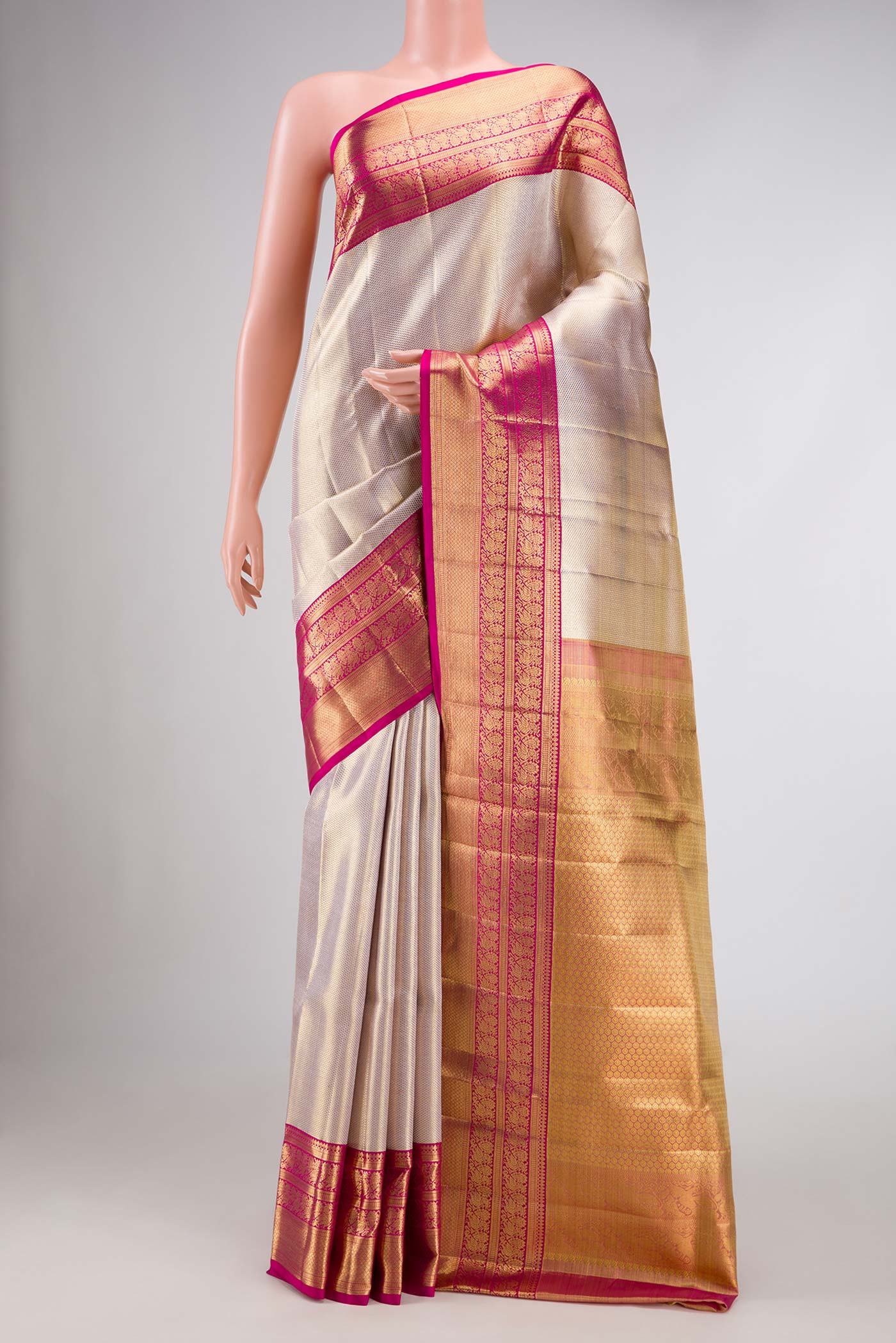 Rose Gold Dual Tone Kanjivaram Tissue Silk Saree with Zari Brocade on the body and Zari Border.  displayed on a mannequin