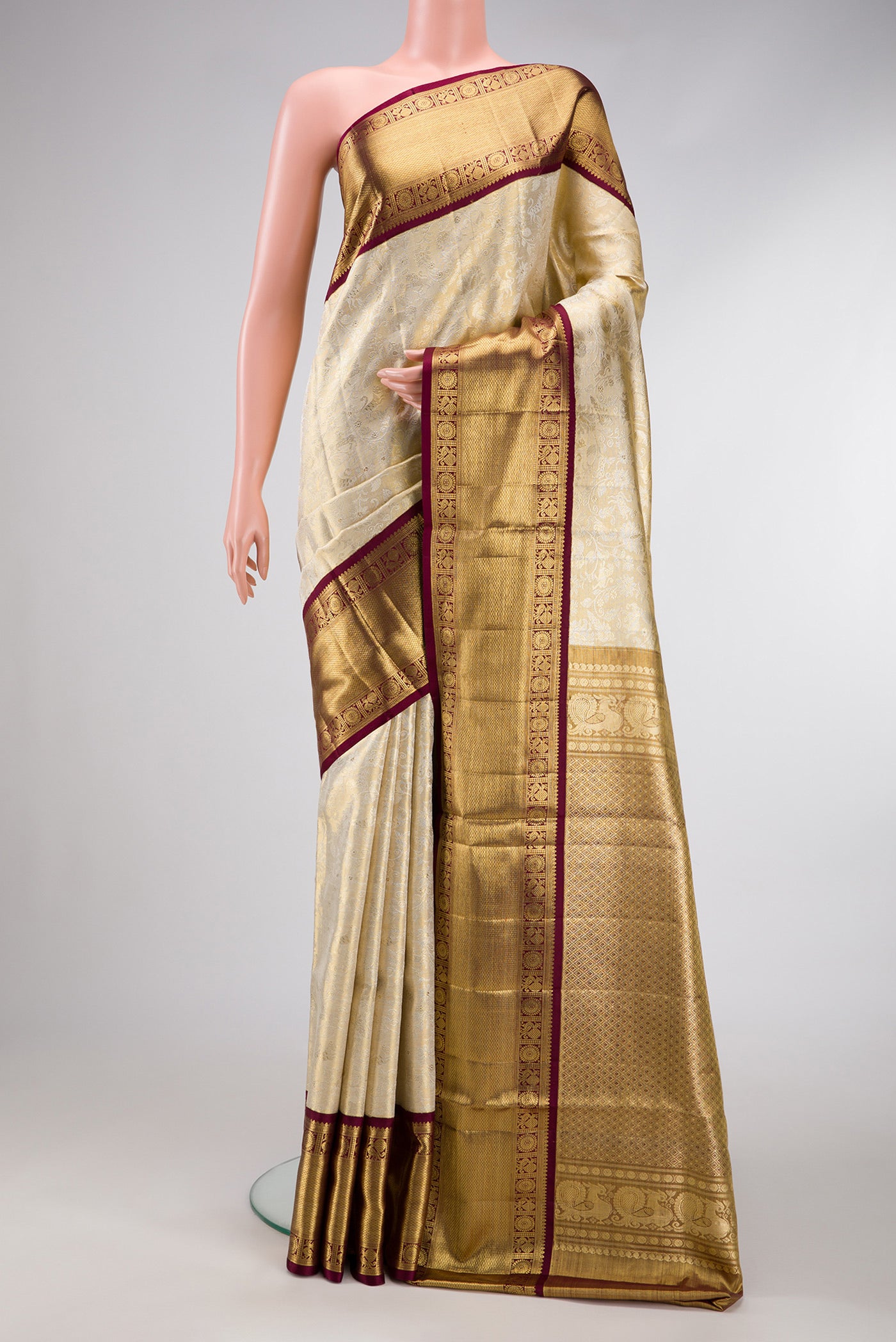 Gold Dual Tone Kanjivaram Tissue Silk Saree with Zari Brocade on the body and Zari Border.  displayed on a mannequin