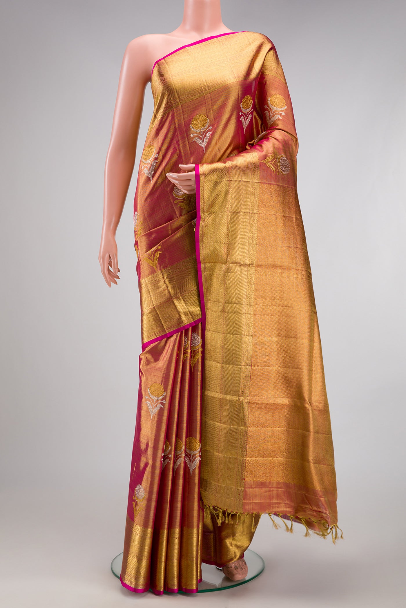 Rose Gold Dual Tone Kanjivaram Tissue Silk Saree with Zari Brocade on the body and Zari Border.  displayed on a mannequin