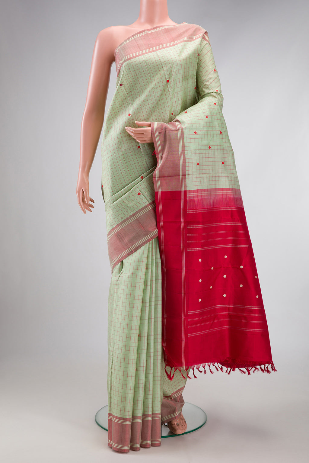 Pista Green Kanjivaram Silk Saree with Checked design on the body and Thread Border.  displayed on a mannequin
