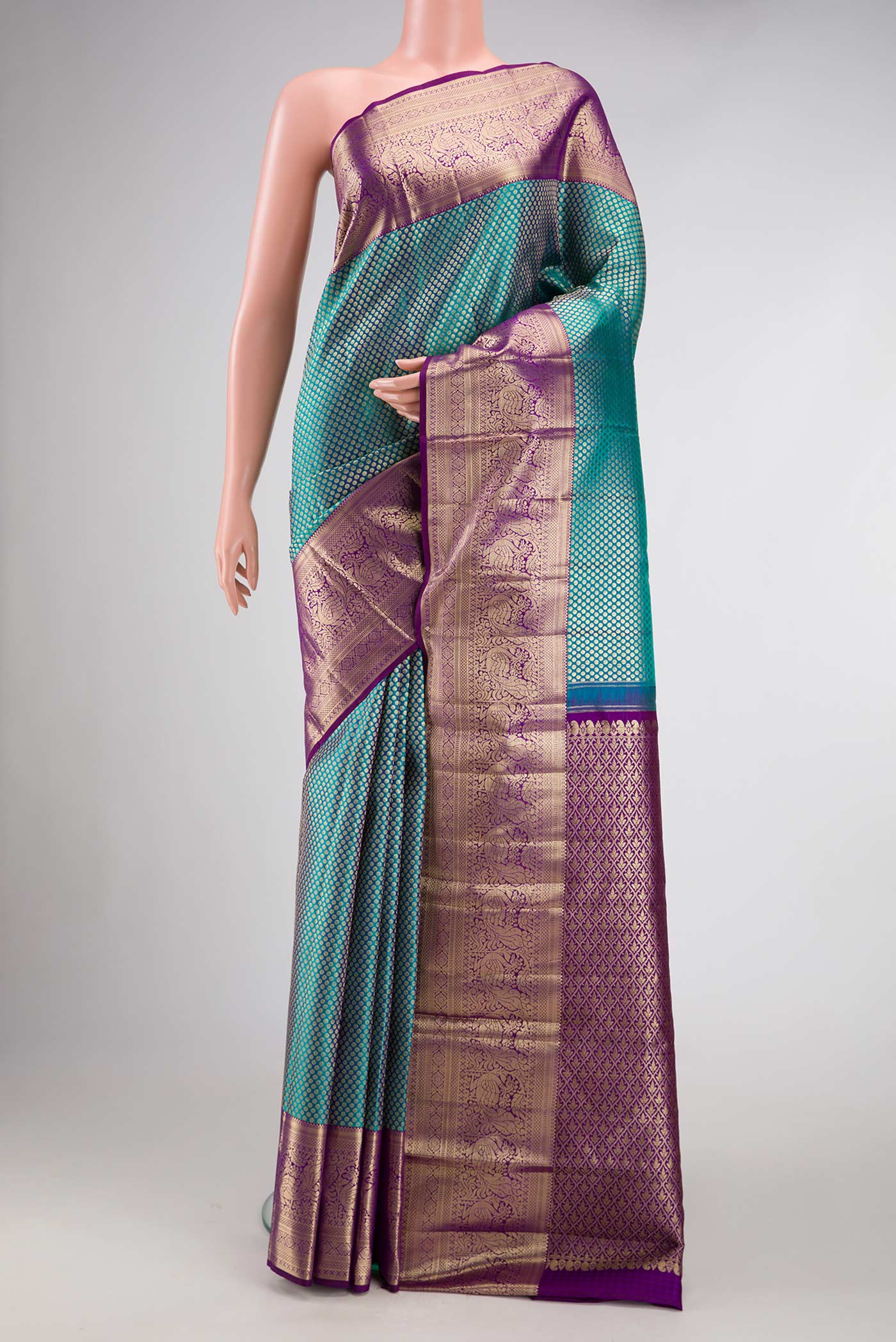 Peacock Blue Dual Tone Kanjivaram Silk Saree with Zari Brocade on the body and Zari Border.  displayed on a mannequin
