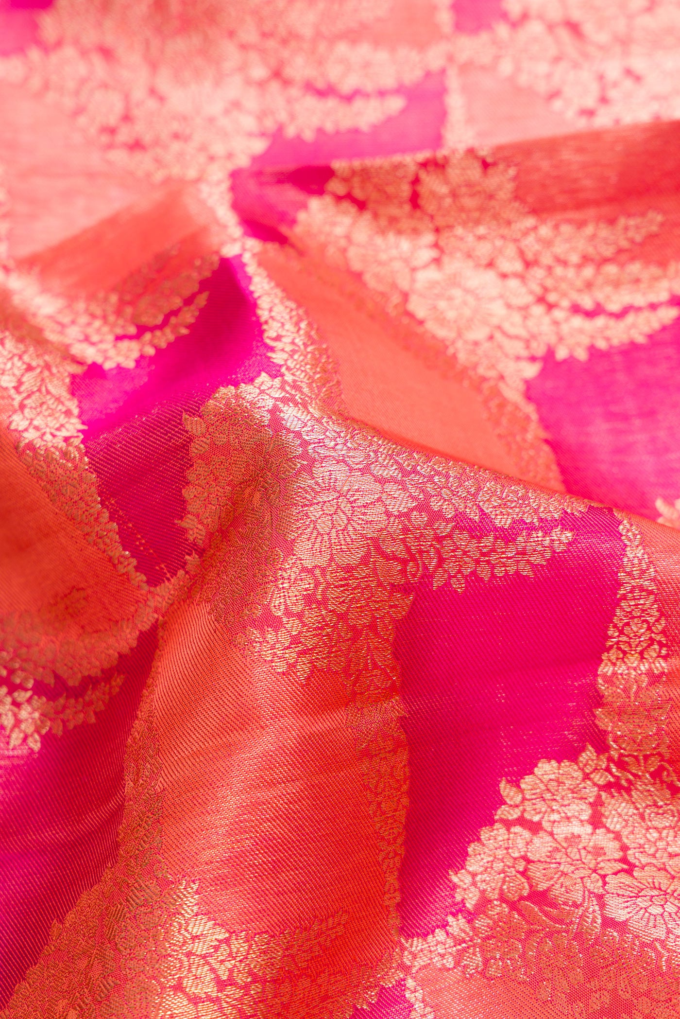 Close up of Pink Dual Tone Kanjivaram Silk Saree with Zari Brocade on the body and Zari Border.  displaying folds