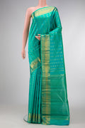 Pure Silk Pure Zari Sea Green Dual Tone Kanjivaram Saree with Zari Butta on the body and Zari Border.  displayed on a mannequin