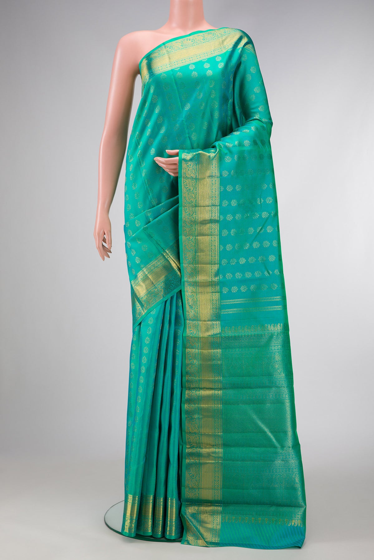 Pure Silk Pure Zari Sea Green Dual Tone Kanjivaram Saree with Zari Butta on the body and Zari Border.  displayed on a mannequin