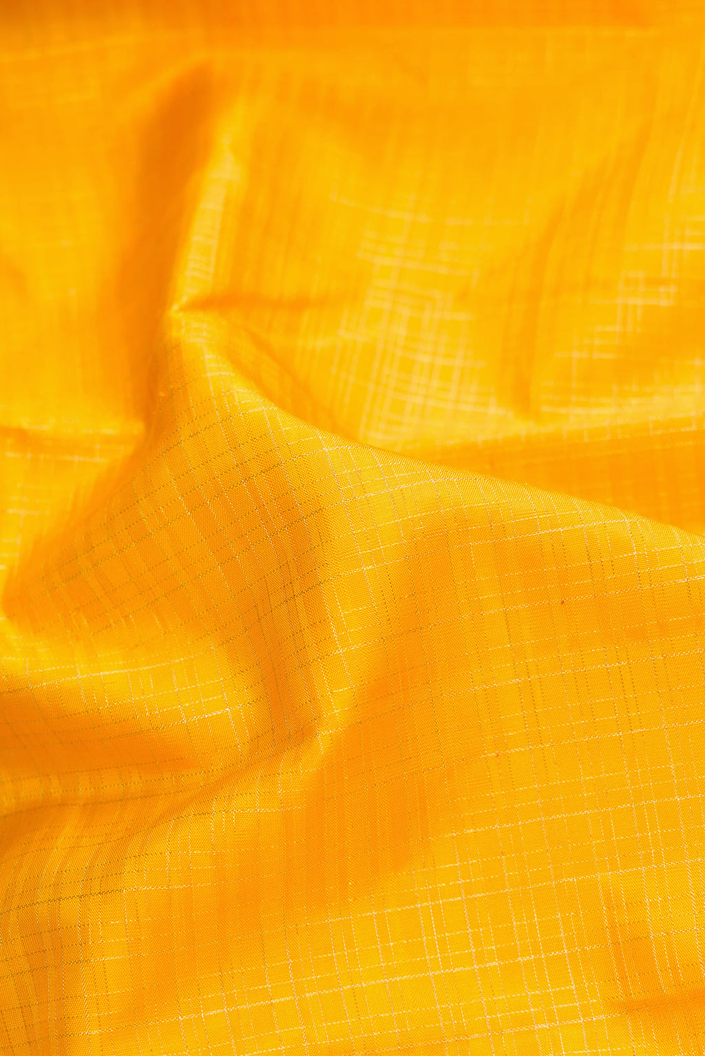 Close up of Yellow Dual Tone Kanchipuram Silk Saree with Checked design on the body and Zari Border.  displaying folds