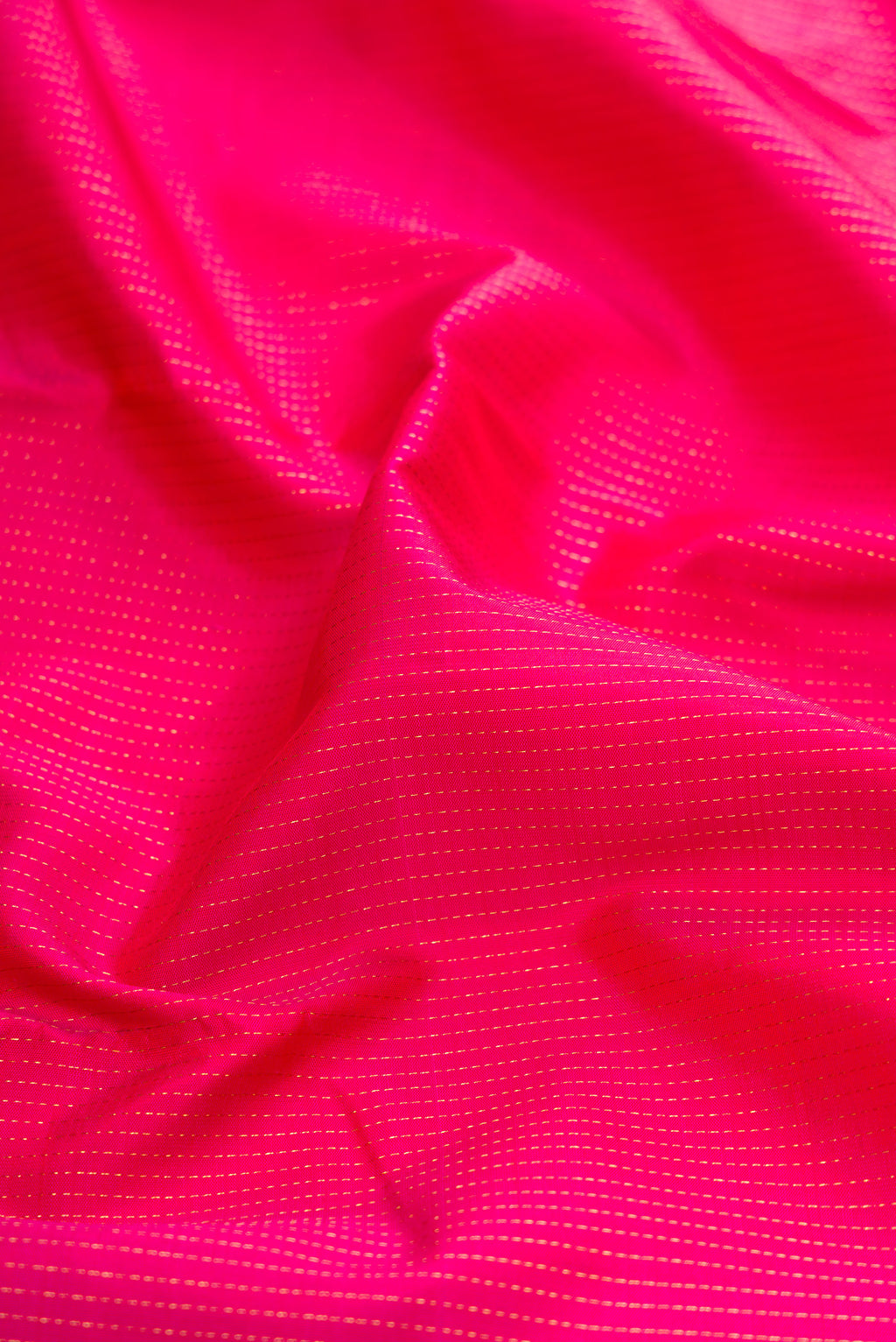 Close up of Dark Pink Kanjivaram Silk Saree with Stripes on the body and Zari Border.  displaying folds