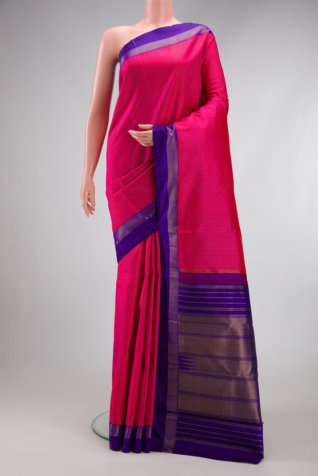 Dark Pink Kanjivaram Silk Saree with Stripes on the body and Zari Border.  displayed on a mannequin