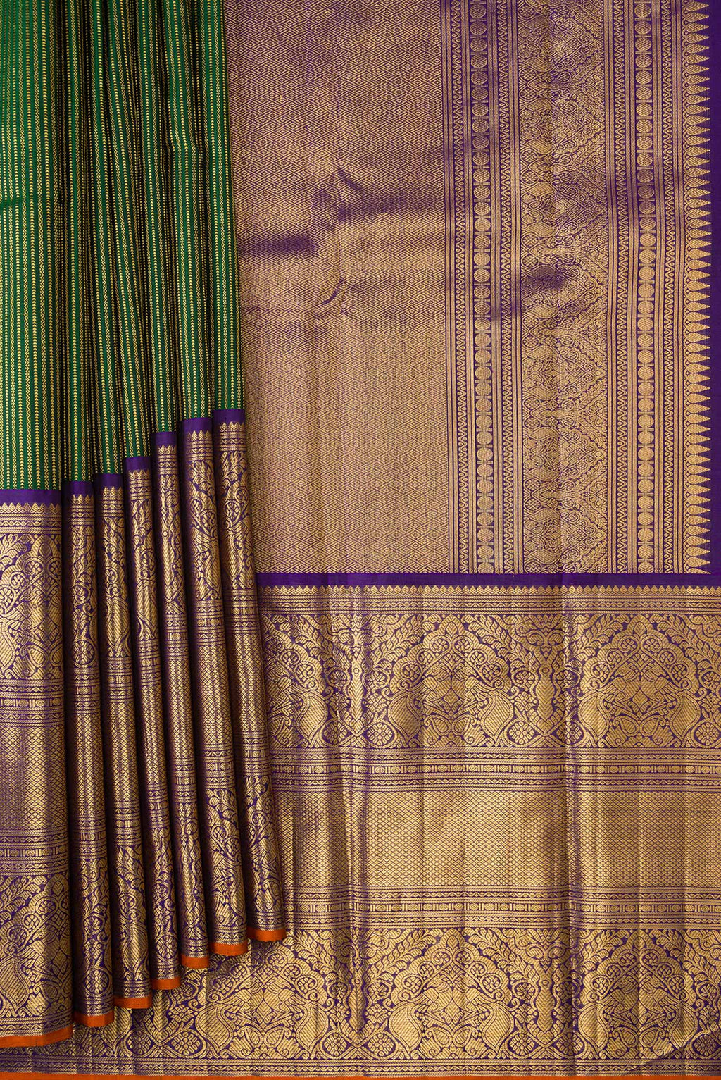 Pleats and pallu of Pure Silk Pure Zari Bottle Green Dual Tone Kanchipuram Saree with Stripes on the body and Zari Border. 